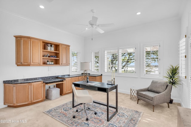 office featuring light carpet, a ceiling fan, and ornamental molding