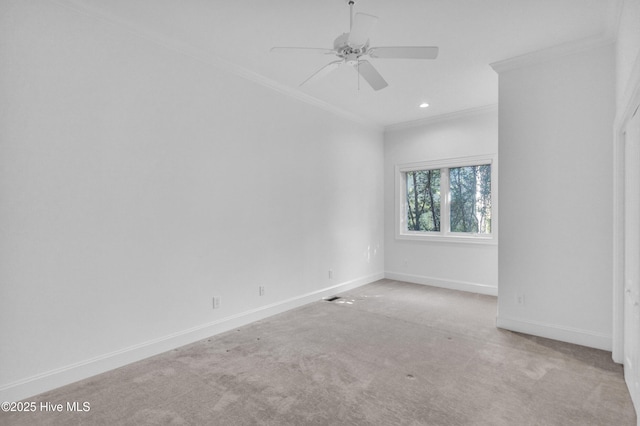carpeted spare room with crown molding, baseboards, ceiling fan, and recessed lighting
