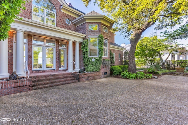 view of front facade featuring french doors and brick siding