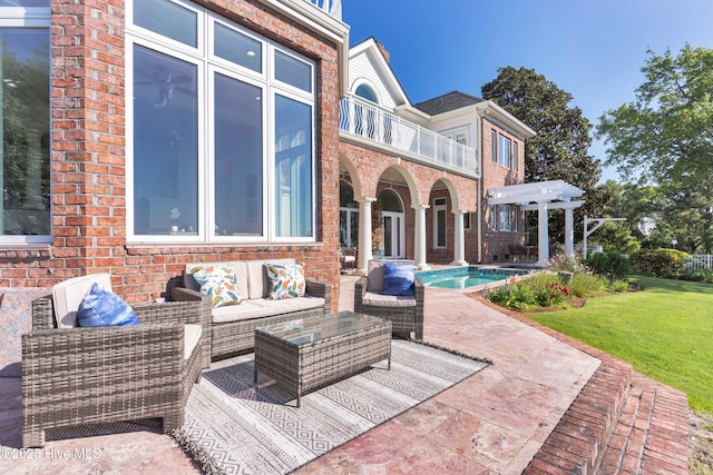 view of patio / terrace featuring an outdoor hangout area, an outdoor pool, and a balcony