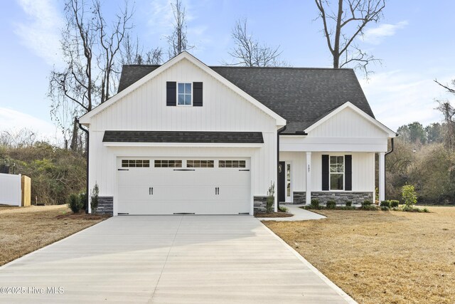 view of front of property featuring a porch and a garage