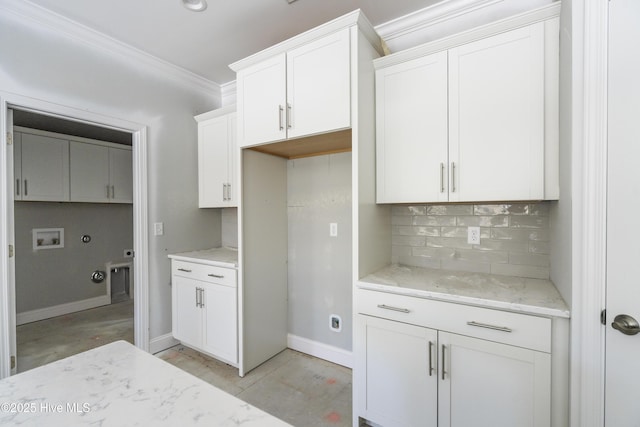 kitchen with crown molding, light stone countertops, decorative backsplash, and white cabinets