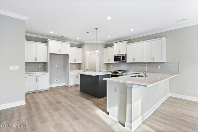 kitchen featuring white cabinetry, pendant lighting, light countertops, and open floor plan