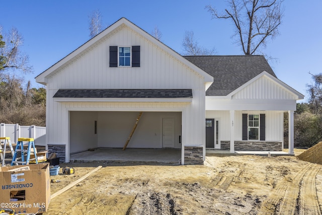 modern inspired farmhouse featuring a garage and a porch