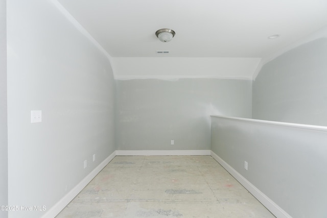 spare room featuring vaulted ceiling