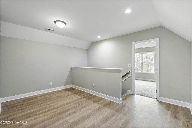 kitchen with light stone counters, stainless steel dishwasher, open floor plan, white cabinets, and a sink