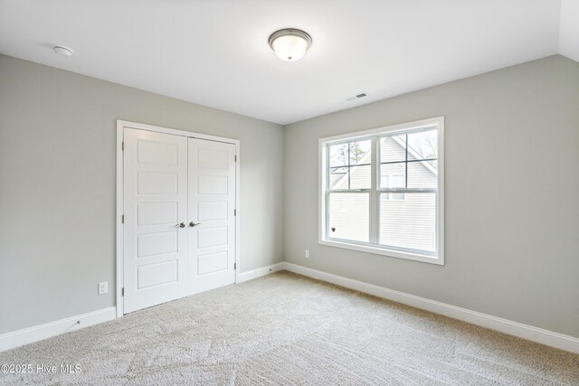 unfurnished bedroom featuring light wood finished floors, recessed lighting, a spacious closet, ornamental molding, and ensuite bath