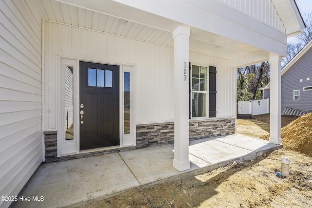 view of exterior entry featuring a porch