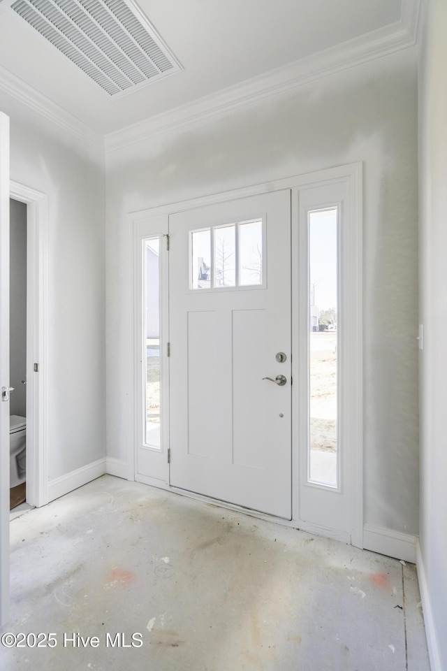 entrance foyer featuring crown molding and plenty of natural light