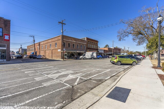 view of building exterior with uncovered parking