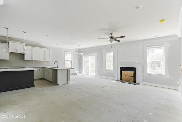 kitchen with sink, decorative light fixtures, ceiling fan, decorative backsplash, and white cabinets