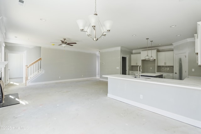 kitchen featuring pendant lighting, sink, white cabinetry, and tasteful backsplash