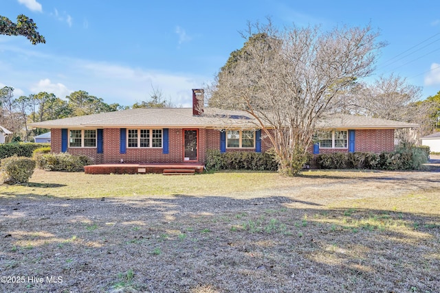 ranch-style home with a front lawn