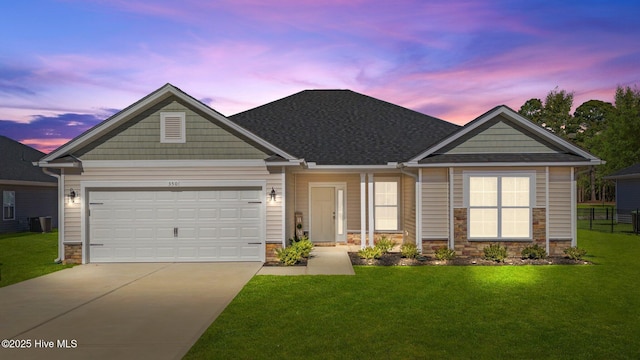 craftsman house with a garage and a lawn