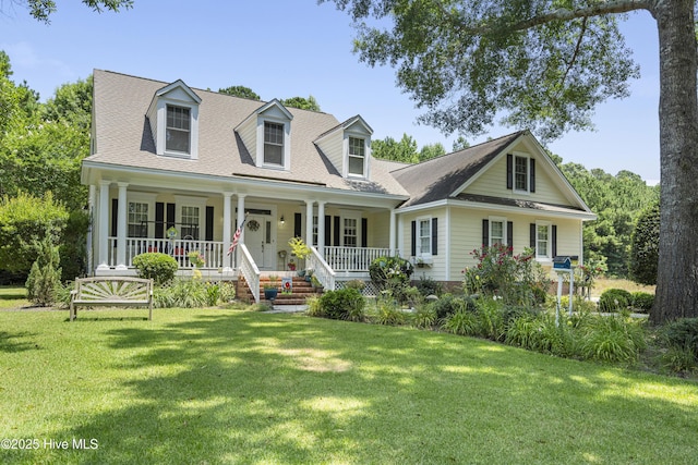 cape cod home with a porch and a front lawn