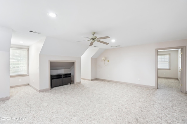 bonus room with lofted ceiling, light colored carpet, and ceiling fan