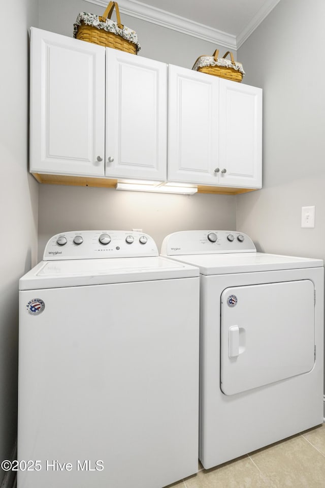 clothes washing area featuring light tile patterned flooring, cabinets, ornamental molding, and separate washer and dryer