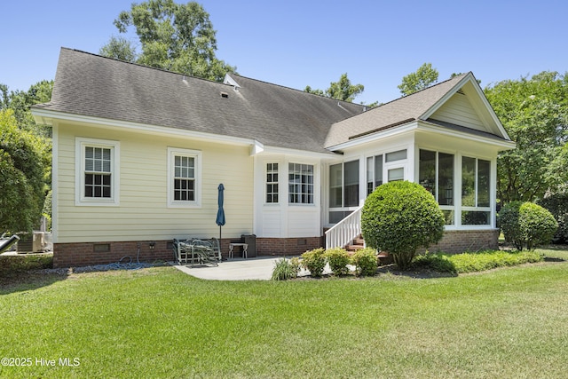 rear view of property with a patio, a sunroom, and a lawn