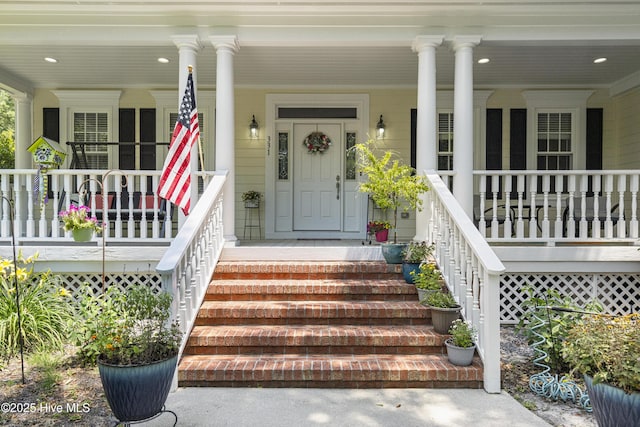 view of exterior entry with a porch