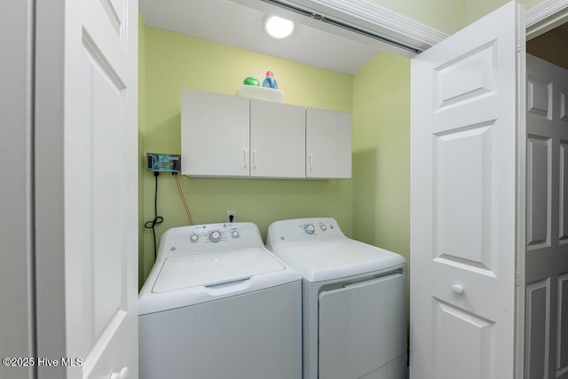 laundry room featuring cabinets and separate washer and dryer