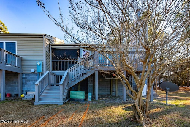 rear view of property featuring a deck