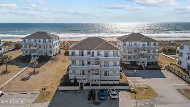 drone / aerial view featuring a water view and a view of the beach