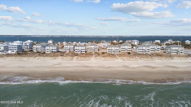 aerial view featuring a view of the beach and a water view