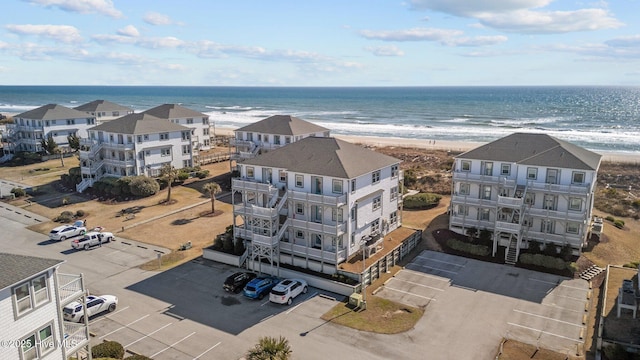 birds eye view of property with a beach view and a water view