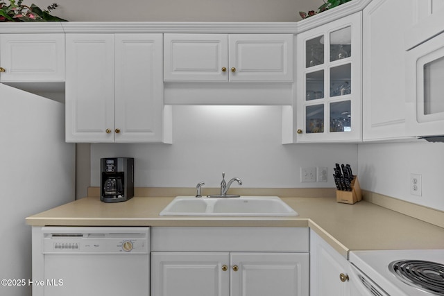 kitchen with sink, white cabinets, and white appliances