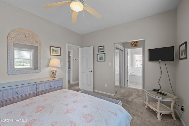 bedroom with light carpet, connected bathroom, and ceiling fan