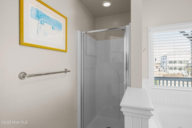 bathroom featuring a shower with door