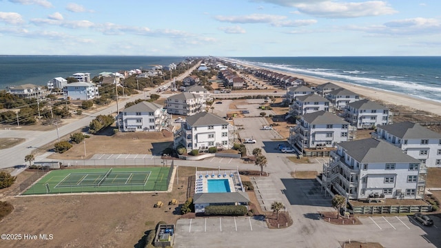 birds eye view of property featuring a water view and a beach view