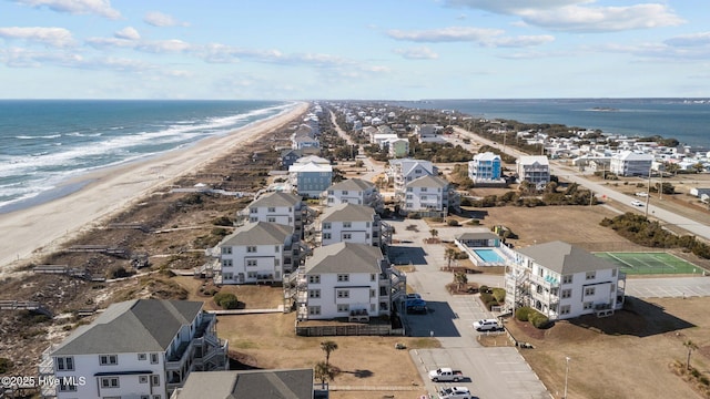 birds eye view of property with a water view and a view of the beach