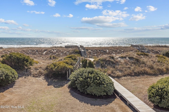 bird's eye view featuring a water view and a view of the beach