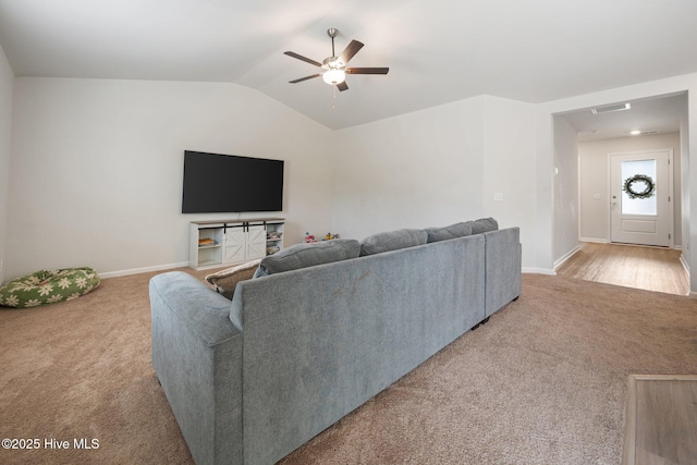 carpeted living room featuring ceiling fan and lofted ceiling