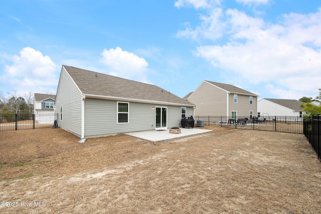 back of house with a fire pit, a patio area, and central AC