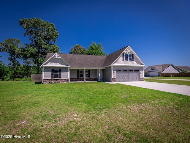 craftsman house featuring a front lawn, board and batten siding, driveway, and stone siding