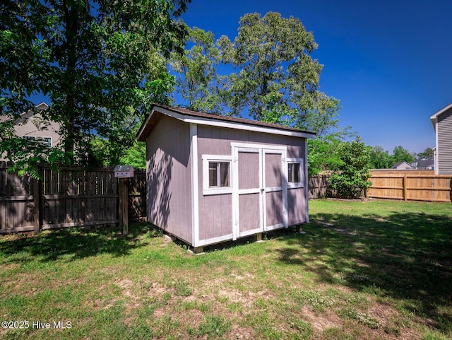 view of shed with a fenced backyard