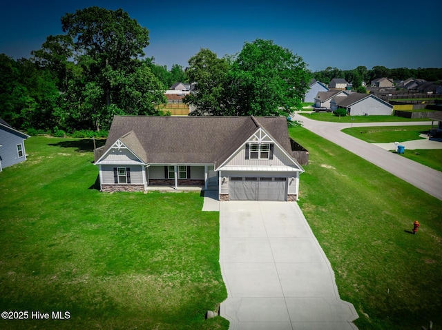 craftsman house featuring board and batten siding, driveway, and a front yard