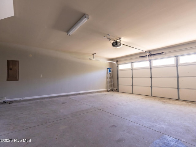 garage featuring baseboards, a garage door opener, and electric panel