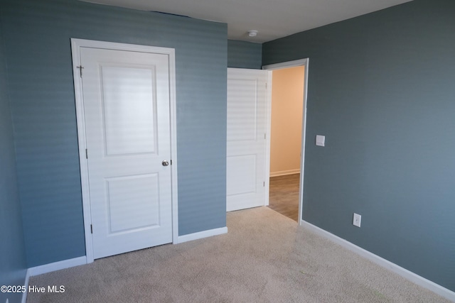 unfurnished bedroom featuring light carpet