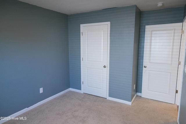 unfurnished bedroom featuring light colored carpet