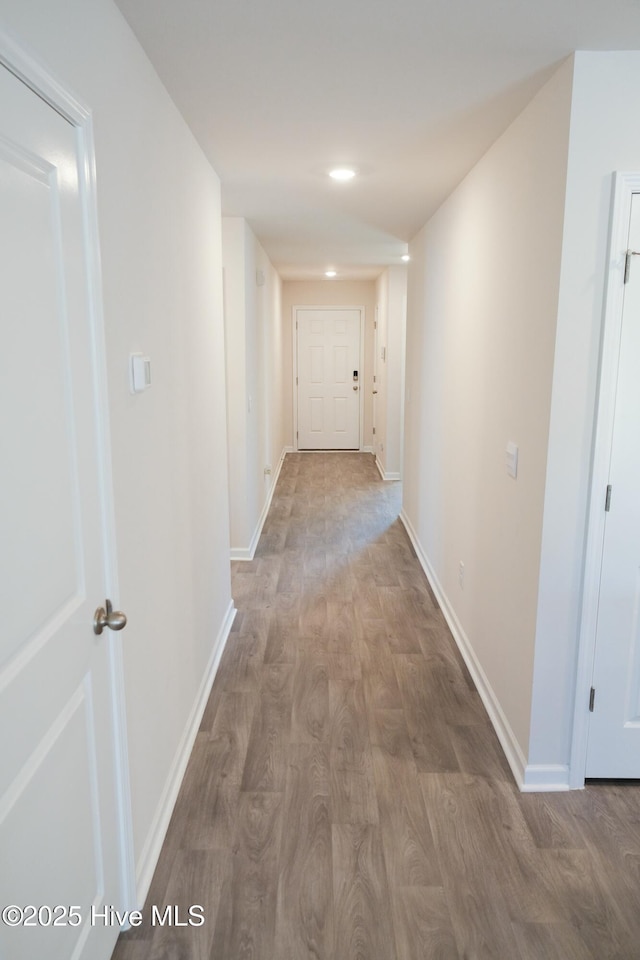 hallway with hardwood / wood-style flooring