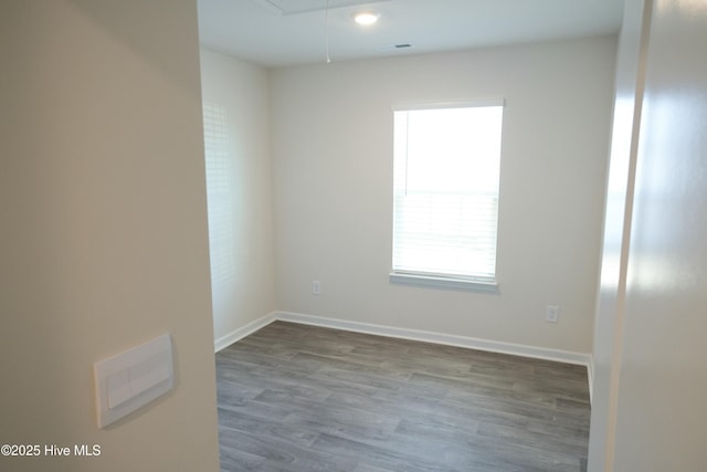 empty room with hardwood / wood-style flooring