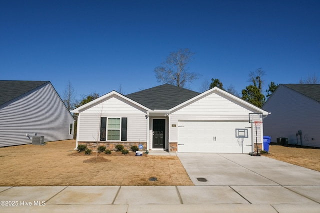 view of front of home featuring a garage and central air condition unit