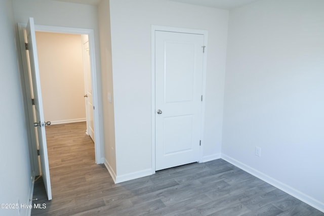 unfurnished bedroom featuring dark wood-type flooring