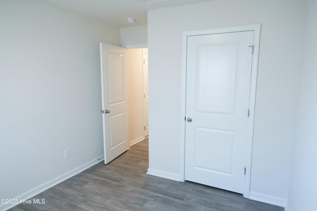 unfurnished bedroom with hardwood / wood-style floors