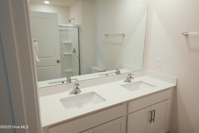 bathroom with an enclosed shower, vanity, and toilet