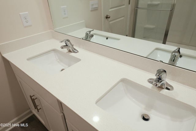 bathroom featuring walk in shower and vanity