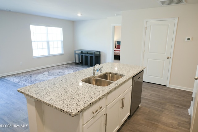 kitchen featuring sink, light stone counters, white cabinets, a center island with sink, and stainless steel dishwasher